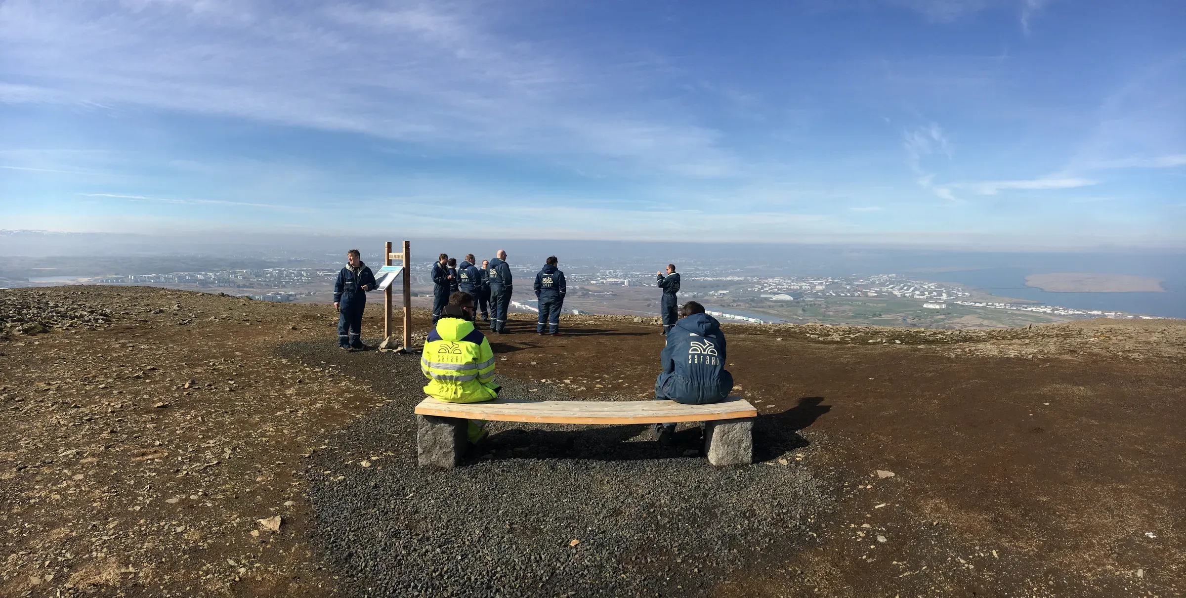 Group at a viewpoint bench on a mountain top overlooking Reykjavík