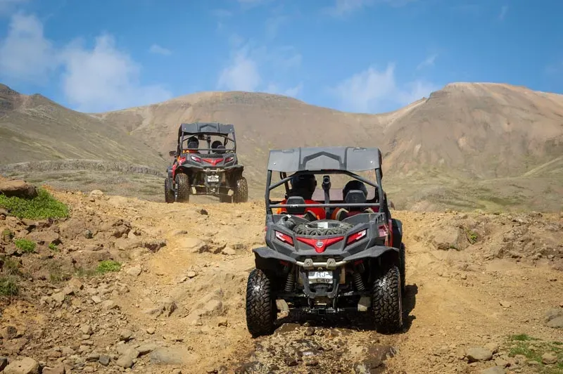 Two buggies parked on a rocky mountain track