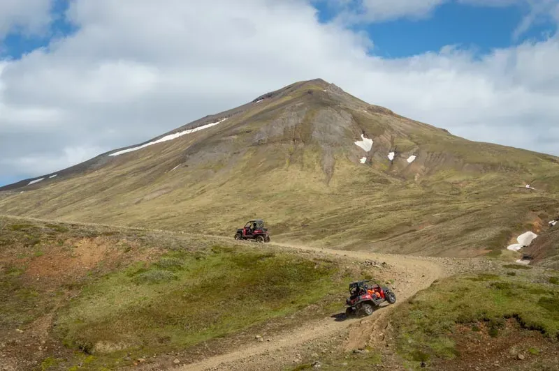 Two buggies driving up a mountain track