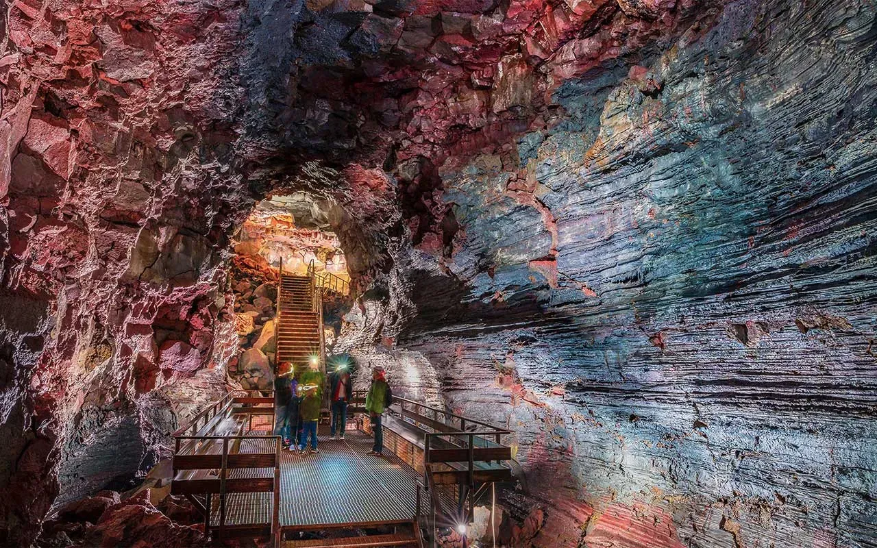 Walkway through the colourful walls of Raufarhólshellir lava tunnel
